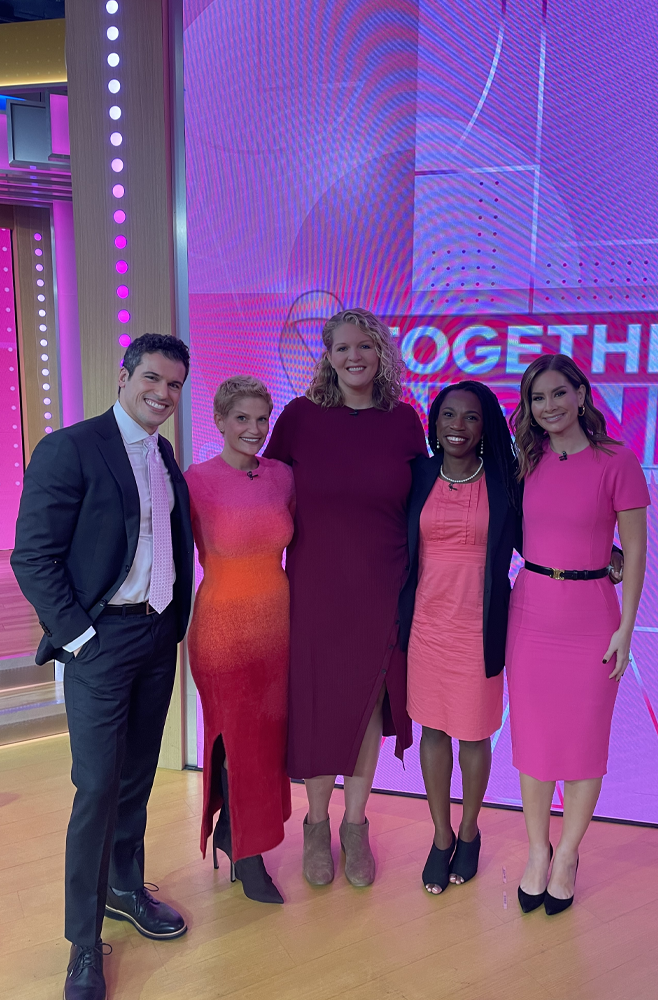 Kate Korson and her care team, all wearing pink outfits, stand in the Good Morning America studio.